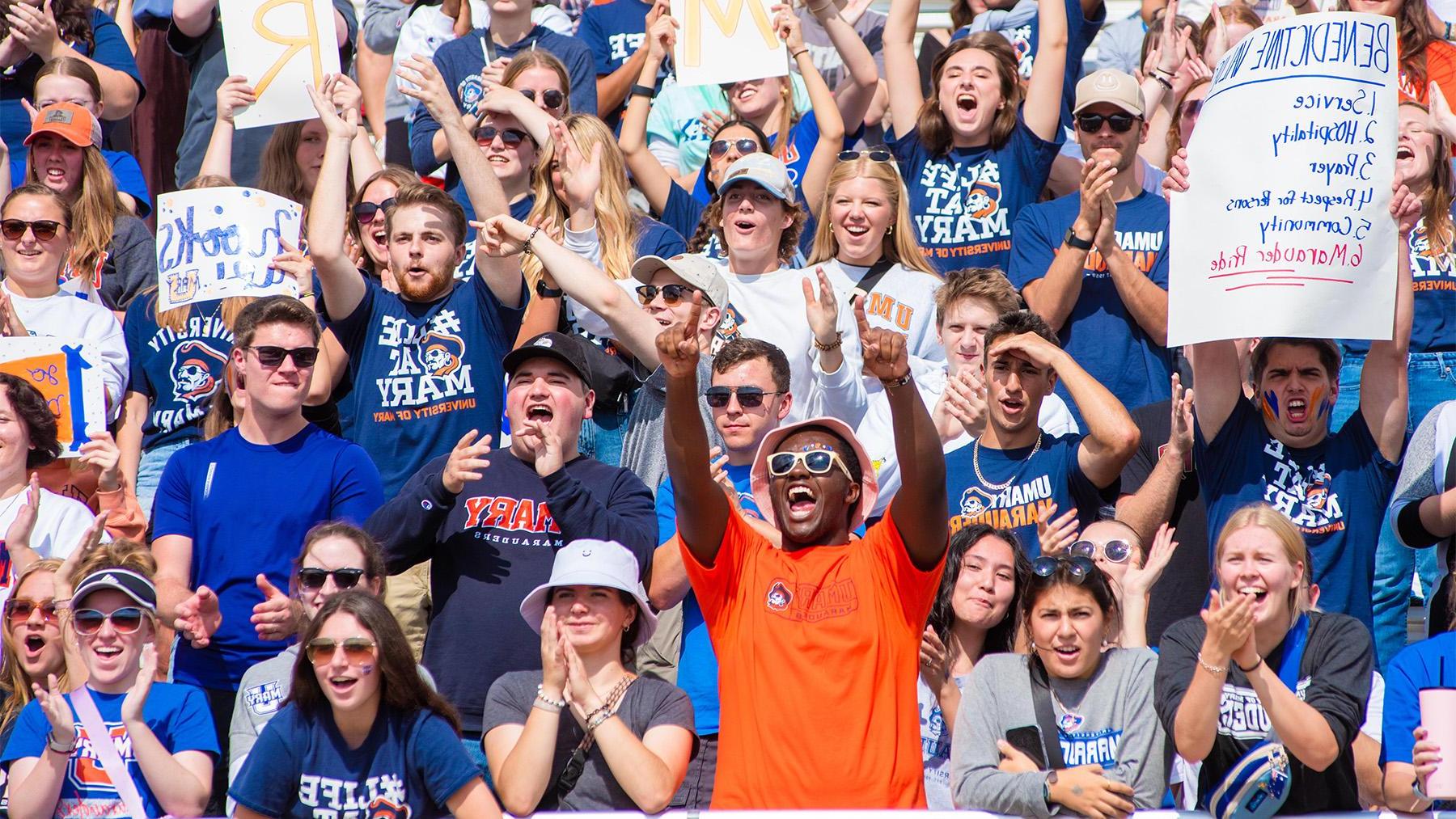 Marauders fans cheering at a football game.